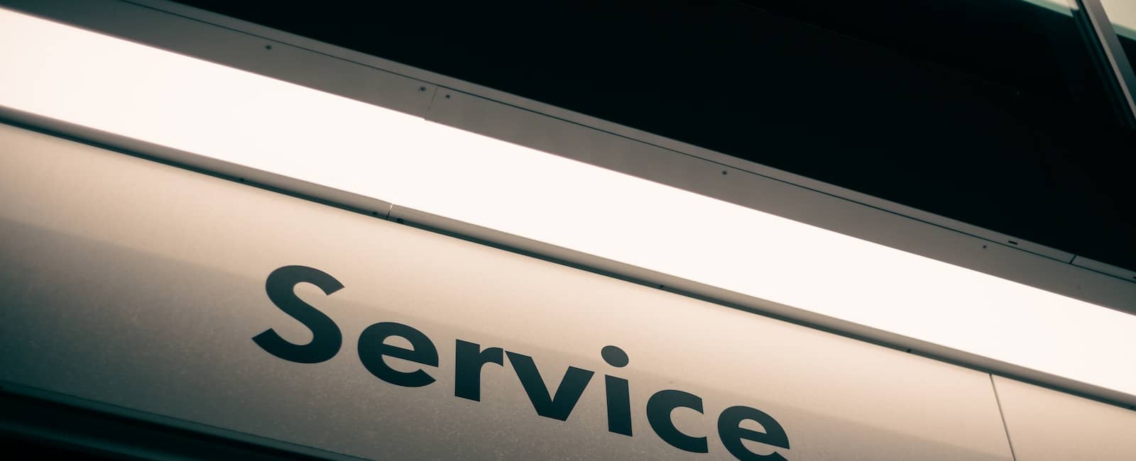 Close-up view of a building sign displaying the word 'Service' in bold letters.