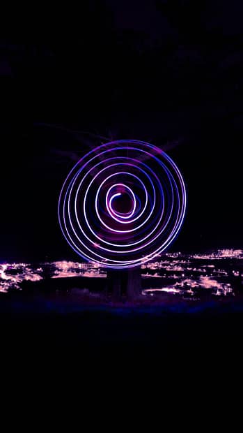 a spinning object in the dark with a sky background