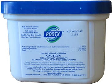 Container of RootX, a root control product, with label displaying active ingredients and caution information.