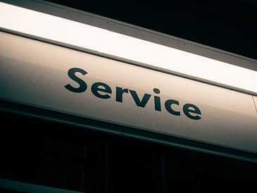 Close-up view of a building sign displaying the word 'Service' in bold letters.