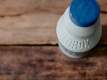 white and blue plastic bottle